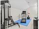 Spacious gym with treadmill, weight machine, and padded flooring at 9927 Clarkes View Nw Pl, Concord, NC 28027