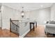 Hallway with chandelier, desk, and seating area at top of the stairs at 9927 Clarkes View Nw Pl, Concord, NC 28027