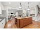 Open kitchen with granite island, custom cabinets, and stainless steel appliances at 9927 Clarkes View Nw Pl, Concord, NC 28027
