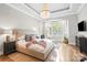 Serene main bedroom with tray ceiling, chandelier, and natural light at 9927 Clarkes View Nw Pl, Concord, NC 28027