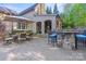 Expansive outdoor patio with dining, seating, and stone bar, perfect for entertaining and relaxation at 9927 Clarkes View Nw Pl, Concord, NC 28027