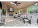 Covered patio featuring a stone fireplace, ceiling fan, and outdoor furniture at 9927 Clarkes View Nw Pl, Concord, NC 28027