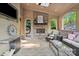 Cozy outdoor patio area with fireplace, comfortable seating, and skylights at 9927 Clarkes View Nw Pl, Concord, NC 28027