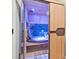 Indoor sauna featuring wood paneling and a glass door at 9927 Clarkes View Nw Pl, Concord, NC 28027