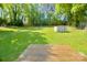 Expansive backyard with a wooden deck and lush green lawn at 1014 Stuart Dr, Wadesboro, NC 28170