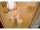 Cozy bathroom with neutral tile flooring and patterned curtains at 1014 Stuart Dr, Wadesboro, NC 28170