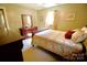 Cozy bedroom featuring warm neutral walls, comfortable bedding, and a large dresser at 1014 Stuart Dr, Wadesboro, NC 28170