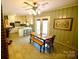 Open concept dining area with backyard access, a breakfast bar, and adjacent kitchen at 1014 Stuart Dr, Wadesboro, NC 28170