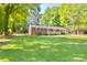 Charming brick home with a well-manicured front yard and mature trees at 1014 Stuart Dr, Wadesboro, NC 28170