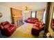 Comfortable living room with a classic brick fireplace, ceiling fan, and supple leather furniture at 1014 Stuart Dr, Wadesboro, NC 28170