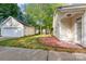Backyard view featuring a detached garage, patio, and ample green space at 10318 Caldwell Depot Rd, Cornelius, NC 28031