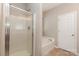Bathroom with a separate shower, soaking tub, and a linen closet for storage at 10318 Caldwell Depot Rd, Cornelius, NC 28031