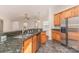 Featuring an open kitchen with granite countertops, stainless steel appliances, and modern fixtures at 10318 Caldwell Depot Rd, Cornelius, NC 28031