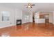 Open-concept living room featuring a fireplace, hardwood floors, and seamless flow into the kitchen at 10318 Caldwell Depot Rd, Cornelius, NC 28031
