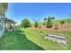 Spacious backyard featuring a covered patio, lush lawn, and landscaped garden beds at 10378 Ambercrest Nw Ct, Huntersville, NC 28078