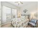 Bright bedroom featuring large windows and a comfortable bed with floral patterned bedding at 10378 Ambercrest Nw Ct, Huntersville, NC 28078