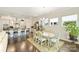 Open-concept dining area with modern lighting, hardwood floors, and kitchen view at 10378 Ambercrest Nw Ct, Huntersville, NC 28078