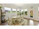 Bright dining room with hardwood floors and many windows showing an enclosed yard with sunlight at 10378 Ambercrest Nw Ct, Huntersville, NC 28078