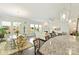 Bright dining room with hardwood floors and many windows connecting to a living room with a fireplace at 10378 Ambercrest Nw Ct, Huntersville, NC 28078