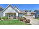 Charming single-Gathering home with attached two-car garage, manicured lawn, and inviting front porch at 10378 Ambercrest Nw Ct, Huntersville, NC 28078