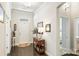 Inviting foyer showcasing hardwood floors, a decorative console table, and an open view to the living spaces at 10378 Ambercrest Nw Ct, Huntersville, NC 28078