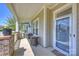 Covered front porch featuring comfortable seating, decorative plants, and a welcoming entrance at 10378 Ambercrest Nw Ct, Huntersville, NC 28078