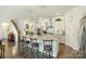 Bright kitchen with gray cabinets, granite counters, stainless appliances, island with bar seating, and hardwood floors at 10378 Ambercrest Nw Ct, Huntersville, NC 28078