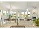 Bright kitchen with island and bar seating, with hardwood floors leading to the dining and living room areas at 10378 Ambercrest Nw Ct, Huntersville, NC 28078