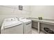 Functional laundry room with modern washer and dryer units and counter space for folding at 10378 Ambercrest Nw Ct, Huntersville, NC 28078