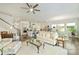 Open-concept living room with hardwood floors, a kitchen view, and modern lighting at 10378 Ambercrest Nw Ct, Huntersville, NC 28078