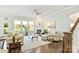Bright living room with a fireplace, ceiling fan, and hardwood floors at 10378 Ambercrest Nw Ct, Huntersville, NC 28078