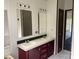 Bathroom featuring double vanity, mirrors, and laminate flooring at 105 Branson Dr, Olin, NC 28660