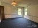 Bedroom with two windows, blue carpet, and a ceiling light fixture at 105 Branson Dr, Olin, NC 28660