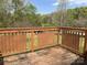 Wood deck featuring patterned railings and view to the exterior with trees in the distance at 105 Branson Dr, Olin, NC 28660