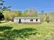 Home's exterior featuring a lawn and trees at 105 Branson Dr, Olin, NC 28660