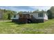 View of home featuring wood deck, brick foundation, and vinyl siding with trees in background at 105 Branson Dr, Olin, NC 28660