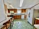 Kitchen featuring plentiful wooden cabinets, microwave, stove, double basin sink, and refrigerator at 105 Branson Dr, Olin, NC 28660