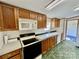Functional kitchen with wooden cabinetry, a microwave, stove, and double basin sink at 105 Branson Dr, Olin, NC 28660