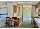 View of the kitchen and dining room with wood cabinets, bar seating, and neutral walls at 105 Branson Dr, Olin, NC 28660