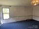 The room boasts carpeted floors and a view from the large single window at 105 Branson Dr, Olin, NC 28660