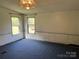 Inviting living room with natural light, with neutral wall colors and blue carpet at 105 Branson Dr, Olin, NC 28660