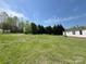 Wide shot of the yard and treeline at 105 Branson Dr, Olin, NC 28660
