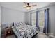 Cozy bedroom with a ceiling fan, bright windows, and a comfortable bed with floral bedding at 105 Sterling Ter, Mooresville, NC 28115