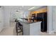 Modern kitchen with breakfast bar and barstools overlooking the living room creating an open floorplan at 105 Sterling Ter, Mooresville, NC 28115