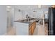 Modern kitchen featuring a breakfast bar with black countertops, sink and view into the living room at 105 Sterling Ter, Mooresville, NC 28115