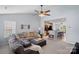 Spacious open concept living room featuring plush sectional sofa with ceiling fan and open view to kitchen at 105 Sterling Ter, Mooresville, NC 28115
