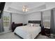 Relaxing main bedroom featuring decorative ceiling fan, large windows and matching nightstands and dresser at 105 Sterling Ter, Mooresville, NC 28115