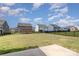 Large backyard with lush grass and an ornate iron fence. Perfect space for entertaining and activities at 1077 Hearth Sw Ln, Concord, NC 28025