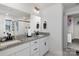 Bathroom featuring double sinks with granite countertops, modern faucets and a large mirror at 1077 Hearth Sw Ln, Concord, NC 28025