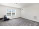 Bright and airy bedroom with a window, neutral walls, and plush carpeting at 1077 Hearth Sw Ln, Concord, NC 28025